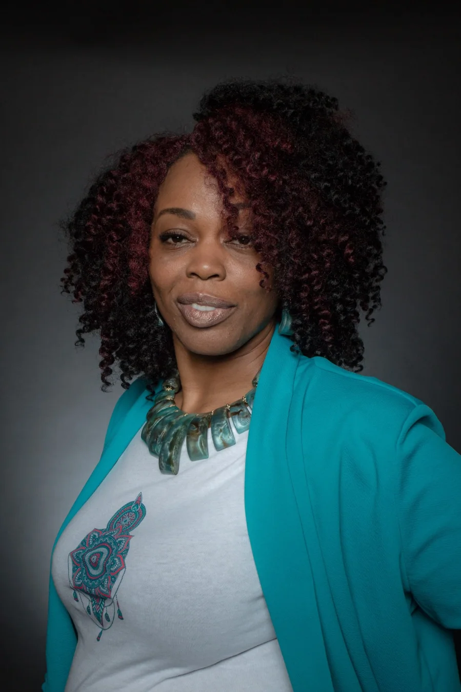 Portrait of Kimberly McFarlane wearing a turquoise jacket